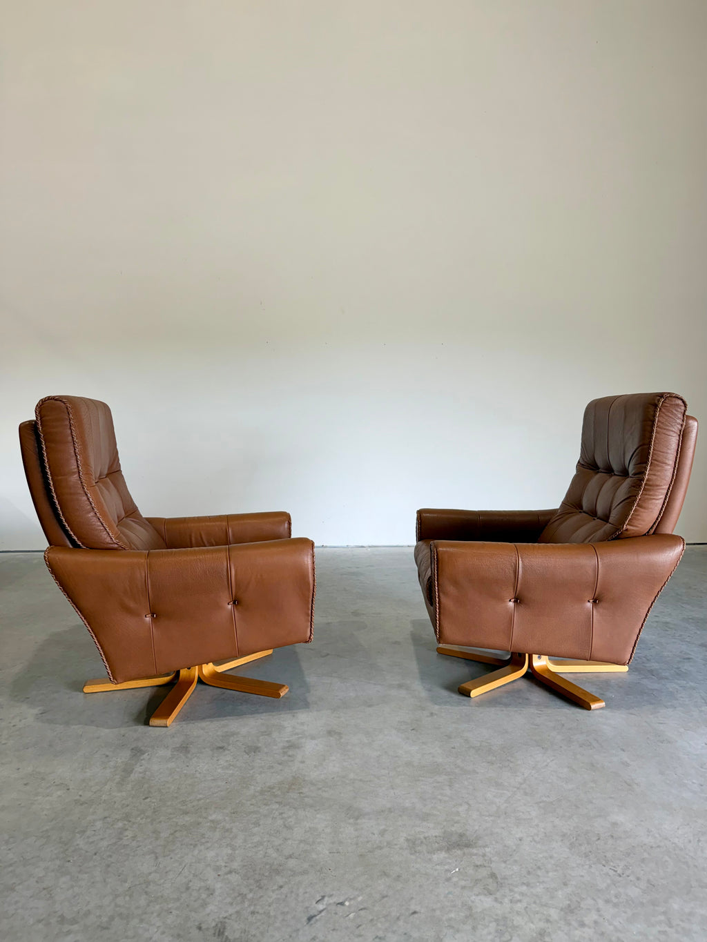 1970’s Danish Caramel Cowboy Leather and Beech Swivel Lounge Chair Pair