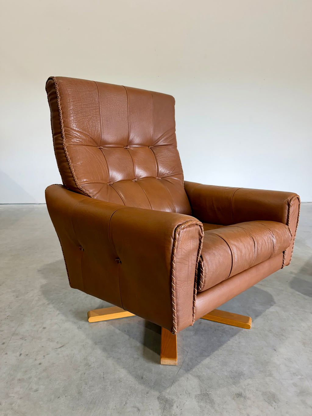 1970’s Danish Caramel Cowboy Leather and Beech Swivel Lounge Chair Pair