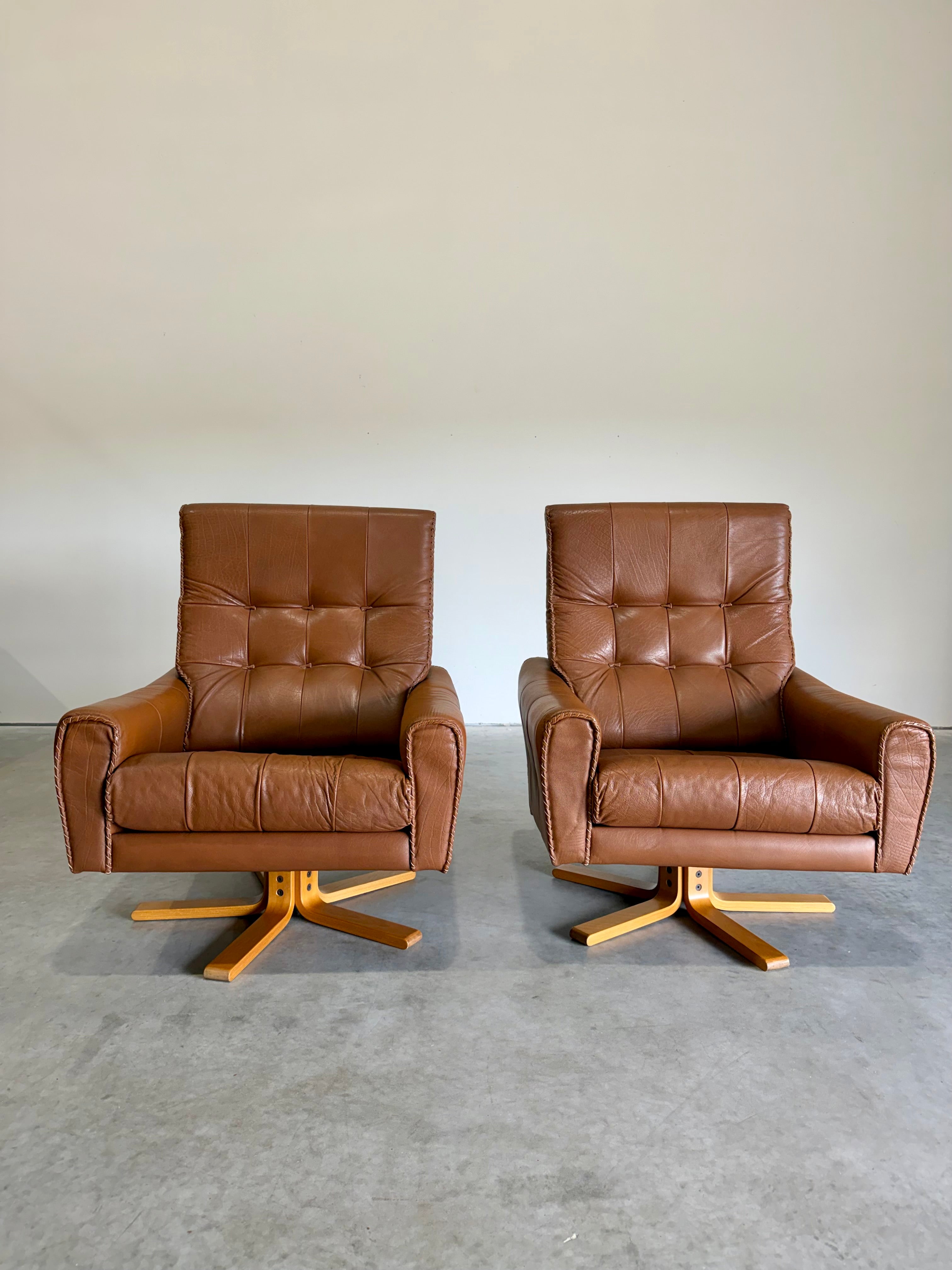 1970’s Danish Caramel Cowboy Leather and Beech Swivel Lounge Chair Pair